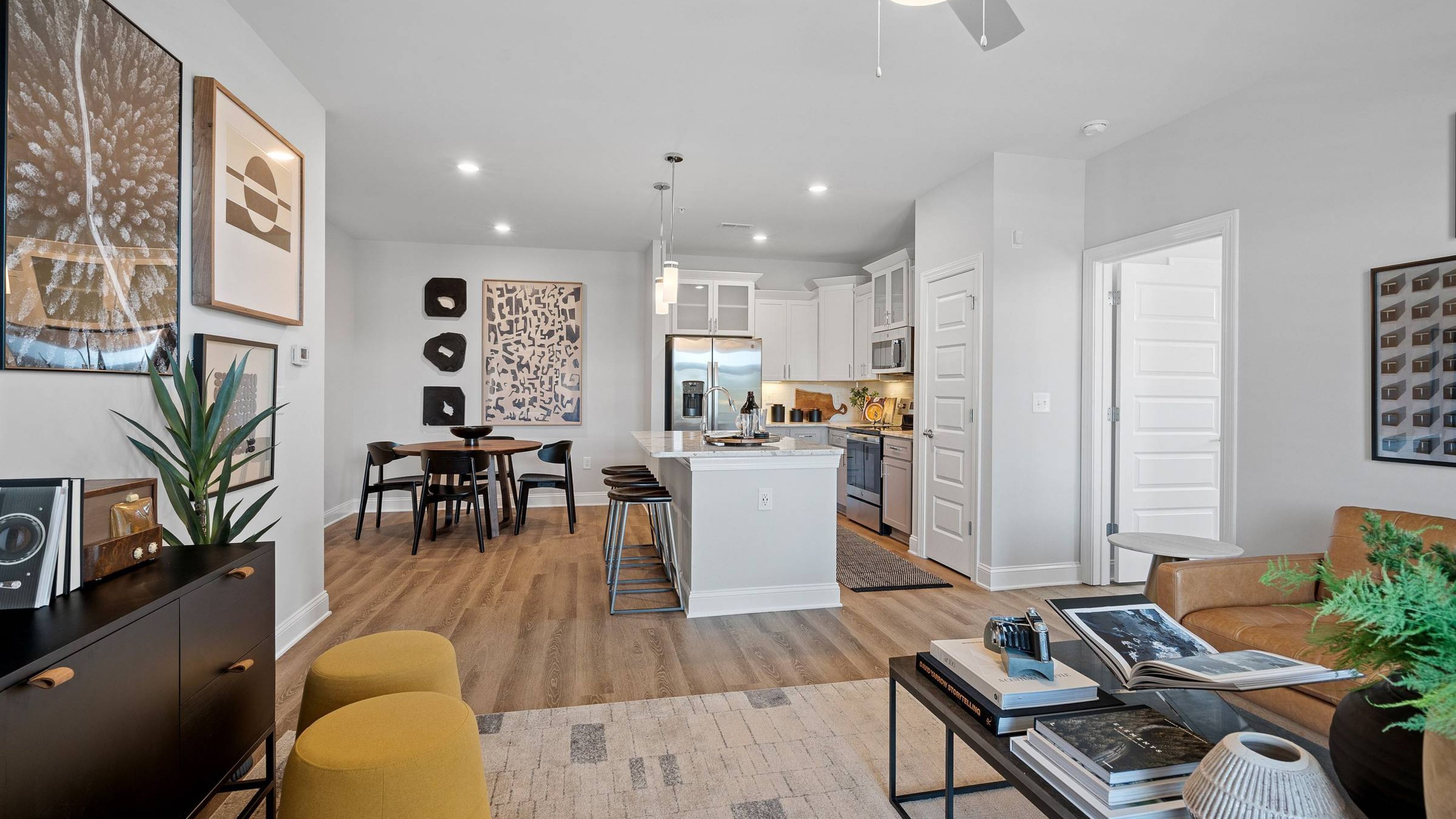 Hawthorne at the Forest apartment kitchen and living area with quartz countertops, stainless steel appliances, and ample cabinet storage