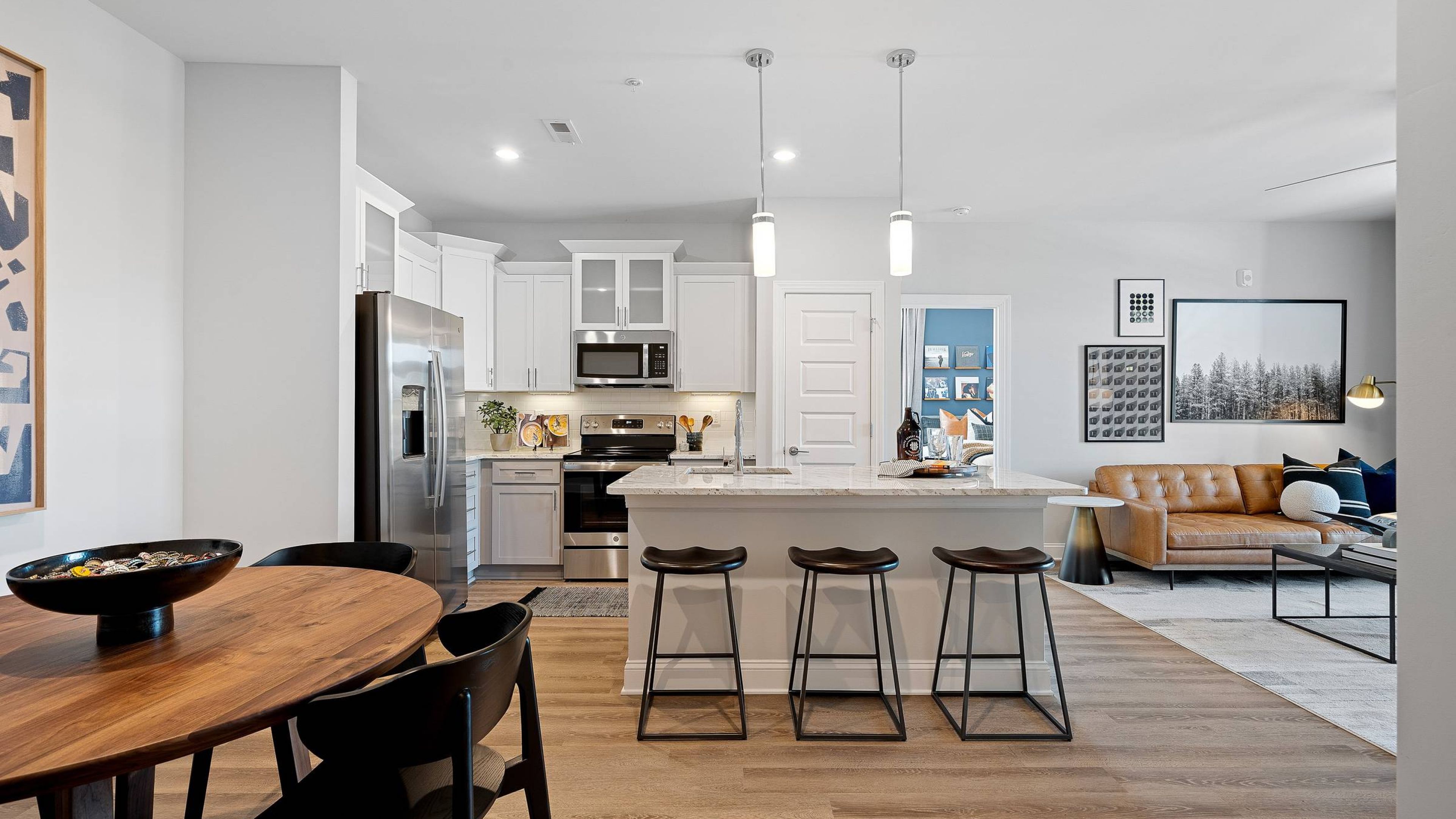 Hawthorne at the Forest apartment kitchen and living space with wood floors and large open plan living area